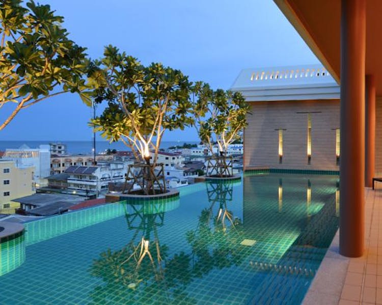 infinity-edge swimming pool at Hisea Hua Hin Hotel with city and sea views.